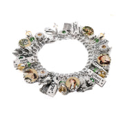 A silver-colored charm bracelet with various charms and pendants attached to it.