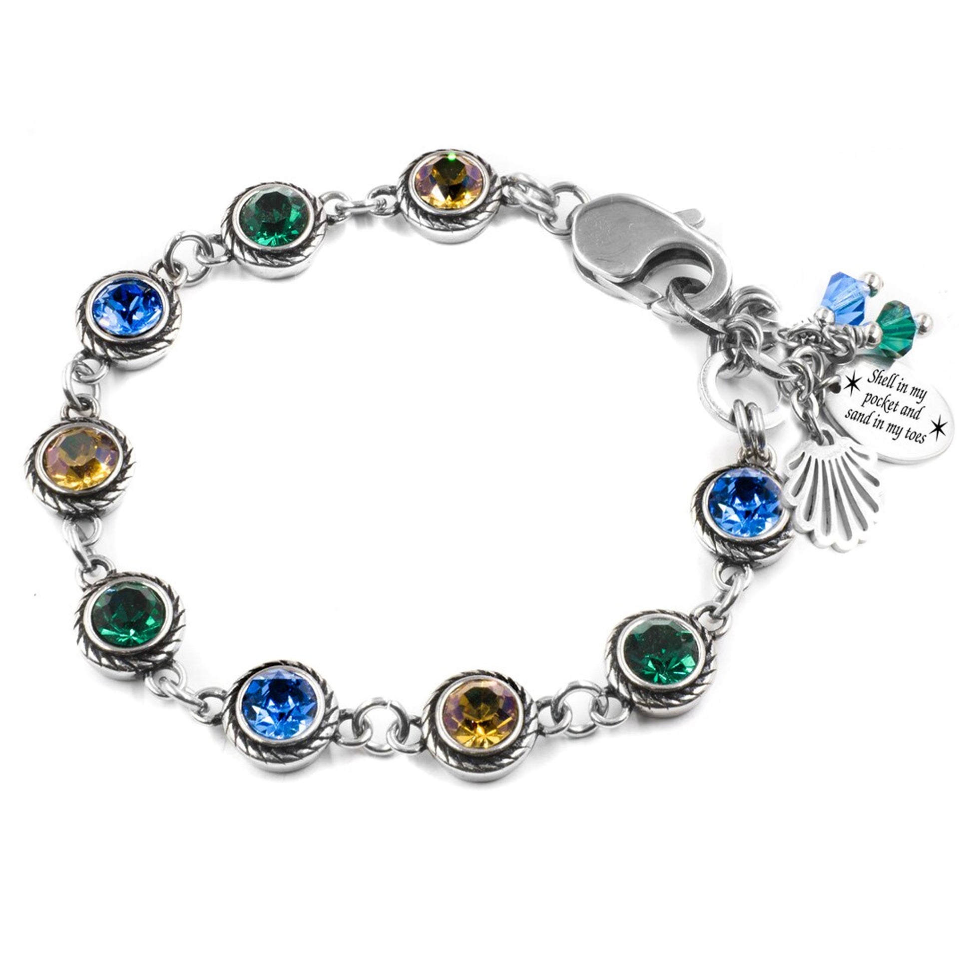 A bracelet with a variety of colorful gemstones, including blue, green, yellow, and orange stones, arranged in a circular pattern. The bracelet also has a charm attached to it, which appears to be a seashell.
