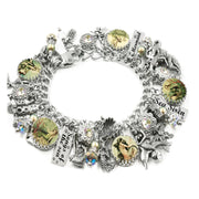A silver charm bracelet adorned with various charms, including a mermaid, sea creatures, and other decorative elements.