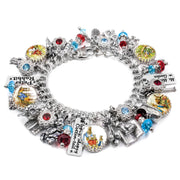 A bracelet adorned with various charms, including a key, a book, and a rabbit, as well as other decorative elements such as gemstones and beads.