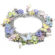 A colorful charm bracelet with various decorative elements, including flowers, butterflies, and pearls.
