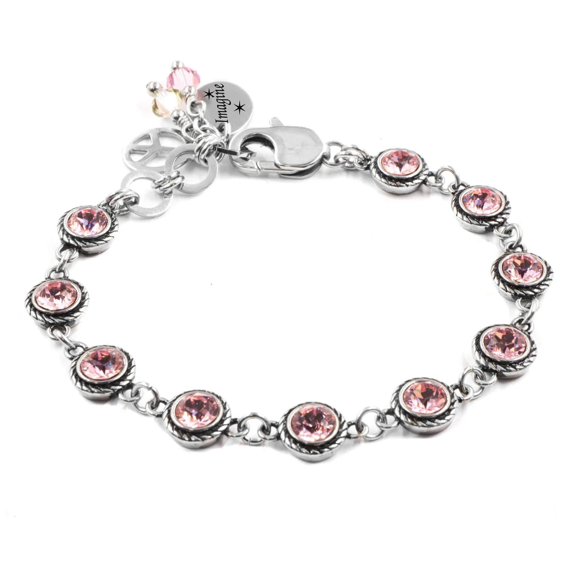 A silver-toned bracelet adorned with multiple round gemstones, including pink and clear stones, creating a visually appealing and elegant design.