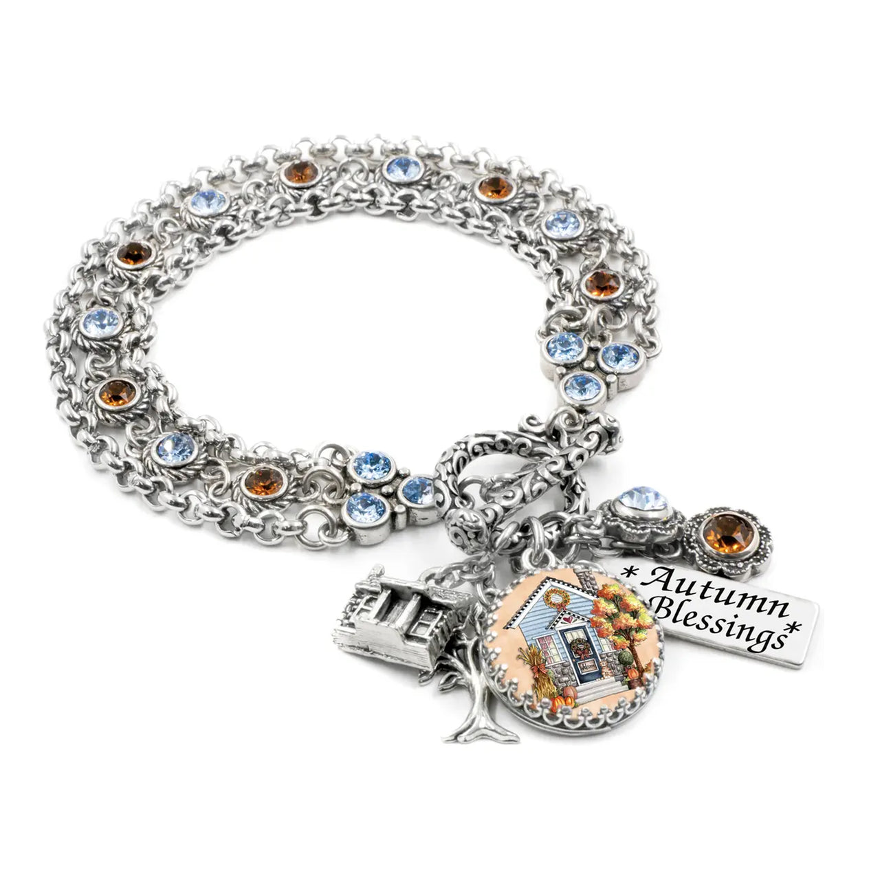 A silver-toned bracelet with various charms and a charm pendant, including a small house charm and a "Autumn Blessings" charm.