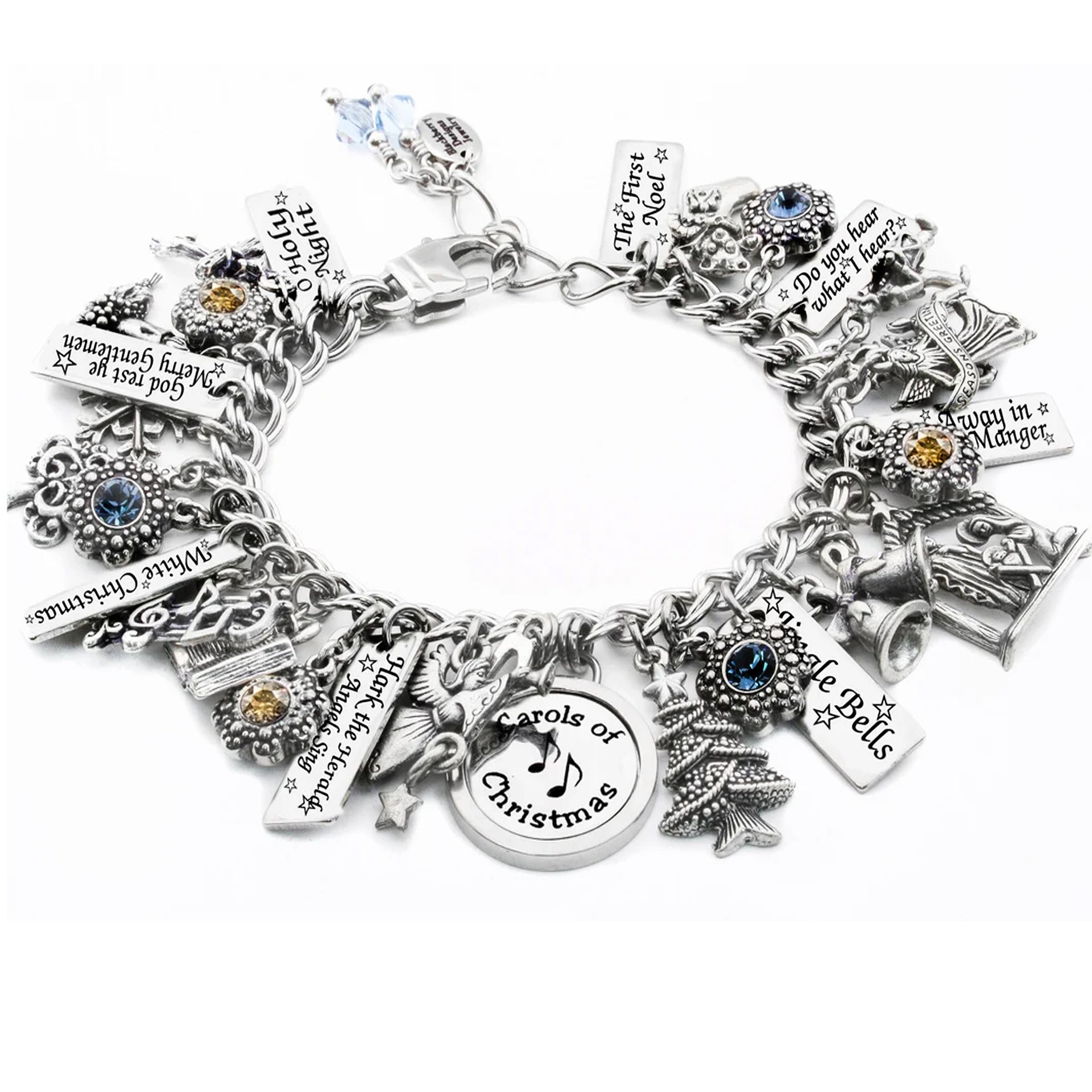 A silver-toned charm bracelet adorned with various charms, including musical notes, a bell, and a Christmas tree, as well as a small blue gemstone.