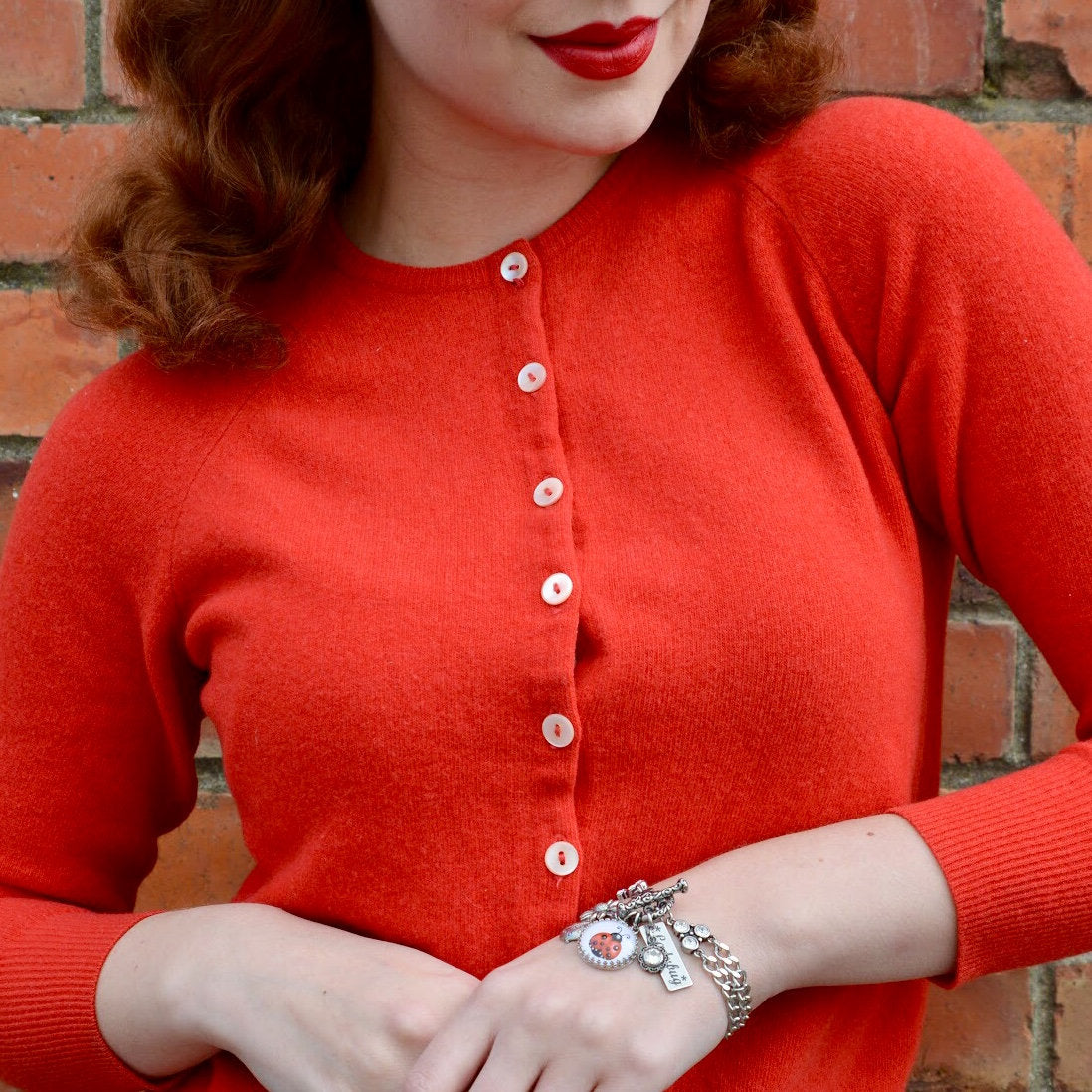closeup of woman wearing ladybug bracelet